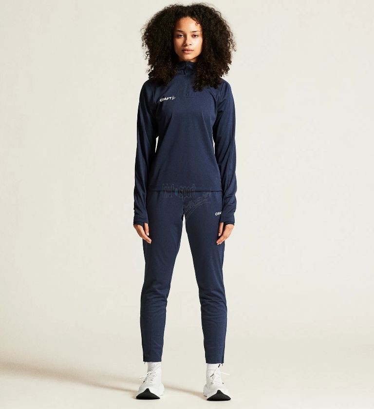 Damski dres treningowy Craft Evolve 2.0 w kolorze granatowym – bluza z krótkim zamkiem pod szyją i techniczne spodnie sportowe z białym logo Craft.
