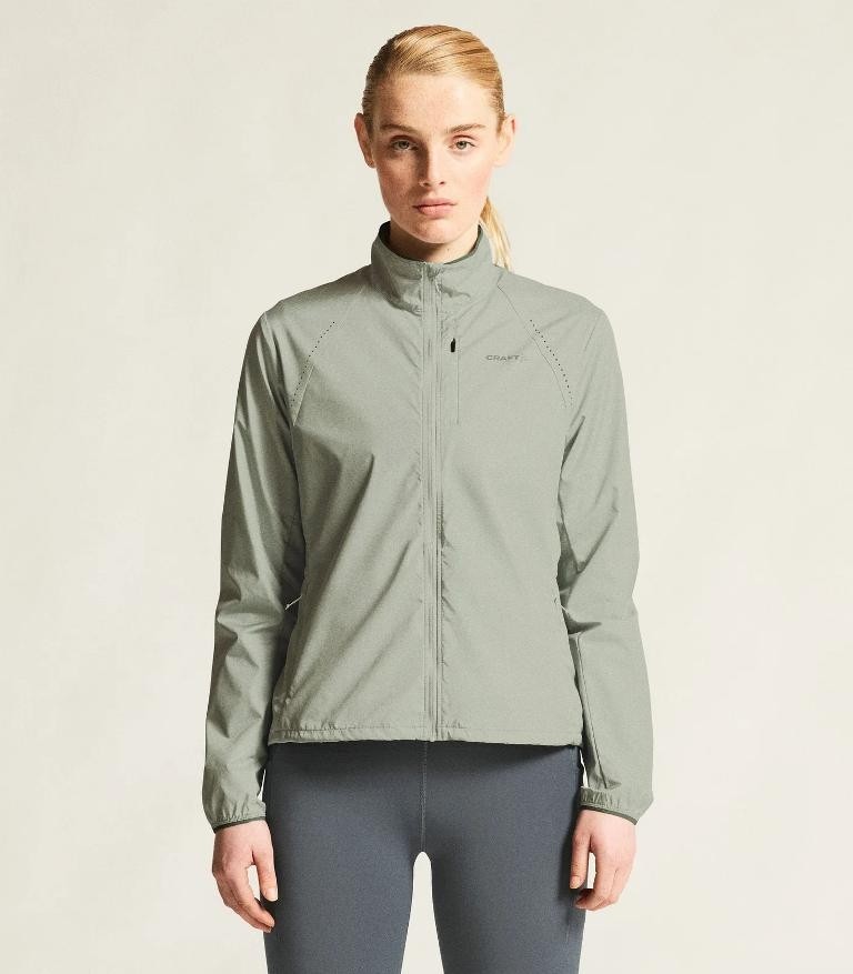 Damska kurtka biegowa Craft Essence Wind Jacket w kolorze jasnopopielatym – lekka wiatrówka treningowa.