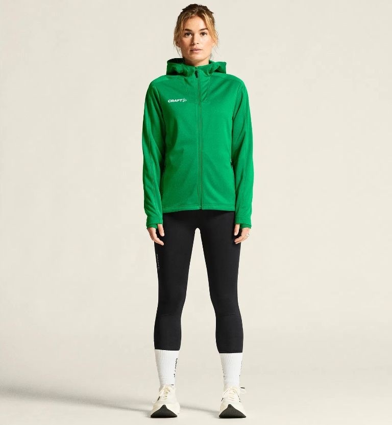 Damski dres treningowy Craft Evolve 2.0 – jaskrawozielona rozpinana bluza z kapturem i czarne legginsy sportowe.
