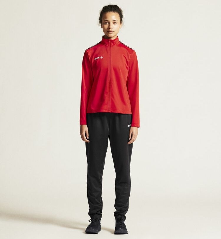 Damski dres treningowy Craft Squad Go – czerwona rozpinana bluza sportowa i czarne spodnie treningowe z białym logo Craft.