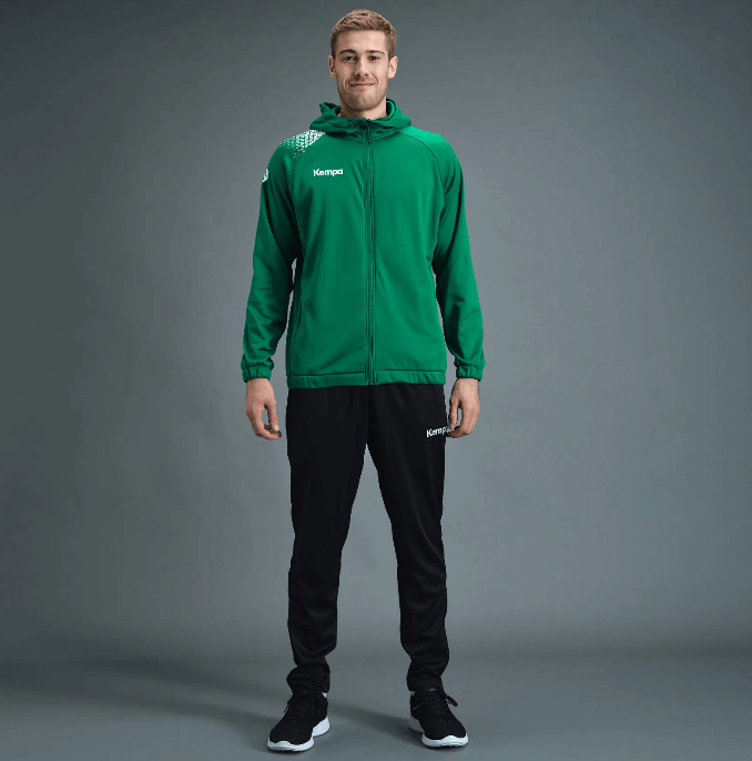 Męski dres treningowy Kempa – zielona bluza Ambition 28 z kapturem i białymi detalami oraz czarne spodnie dresowe Kempa Motion.