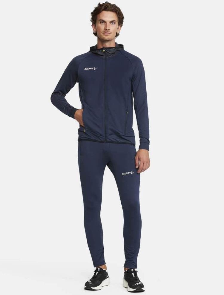 Granatowy męski dres treningowy CRAFT Extend PREMIUM – techniczna bluza z kapturem i zamkiem oraz dopasowane spodnie dresowe.