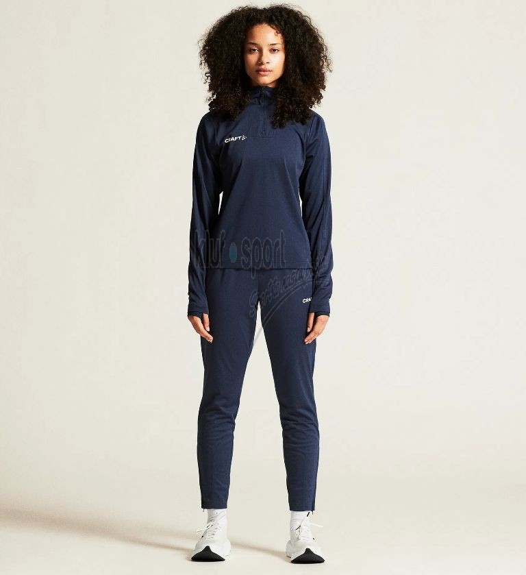 Damski dres treningowy Craft Evolve 2.0 w kolorze granatowym – bluza z krótkim zamkiem pod szyją i techniczne spodnie sportowe z białym logo Craft.