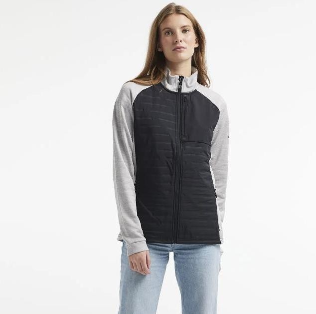 Damska kurtka sportowa Craft ADV Unify Hybrid – hybrydowa konstrukcja z pikowanym szarym przodem i czarnymi elastycznymi rękawami oraz kapturem.