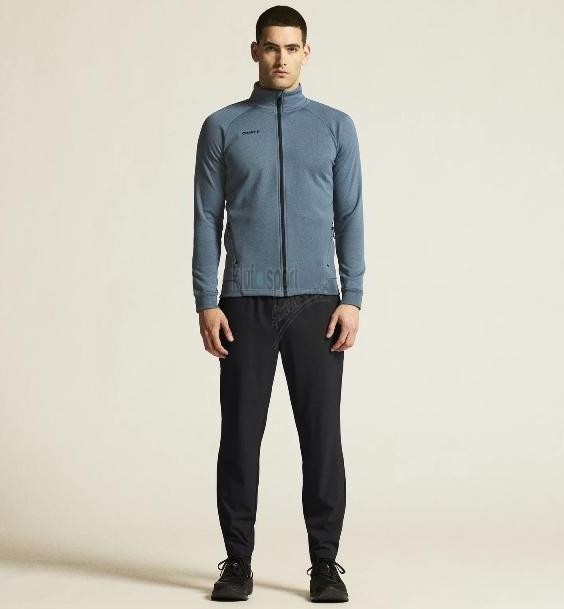 Męski dres sportowy z linii premium Craft ADV Unify – niebieska rozpinana bluza ze stójką i czarne spodnie dresowe o profesjonalnym wykończeniu.