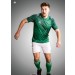 Męski komplet piłkarski Stanno – zielona koszulka meczowa Hatch z białymi detalami oraz białe spodenki Focus II z zielonym wykończeniem.