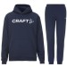 Męski dres bawełniany Craft Community 2.0 – granatowa bluza z kapturem i kieszenią typu kangurka oraz dopasowane granatowe spodnie dresowe.